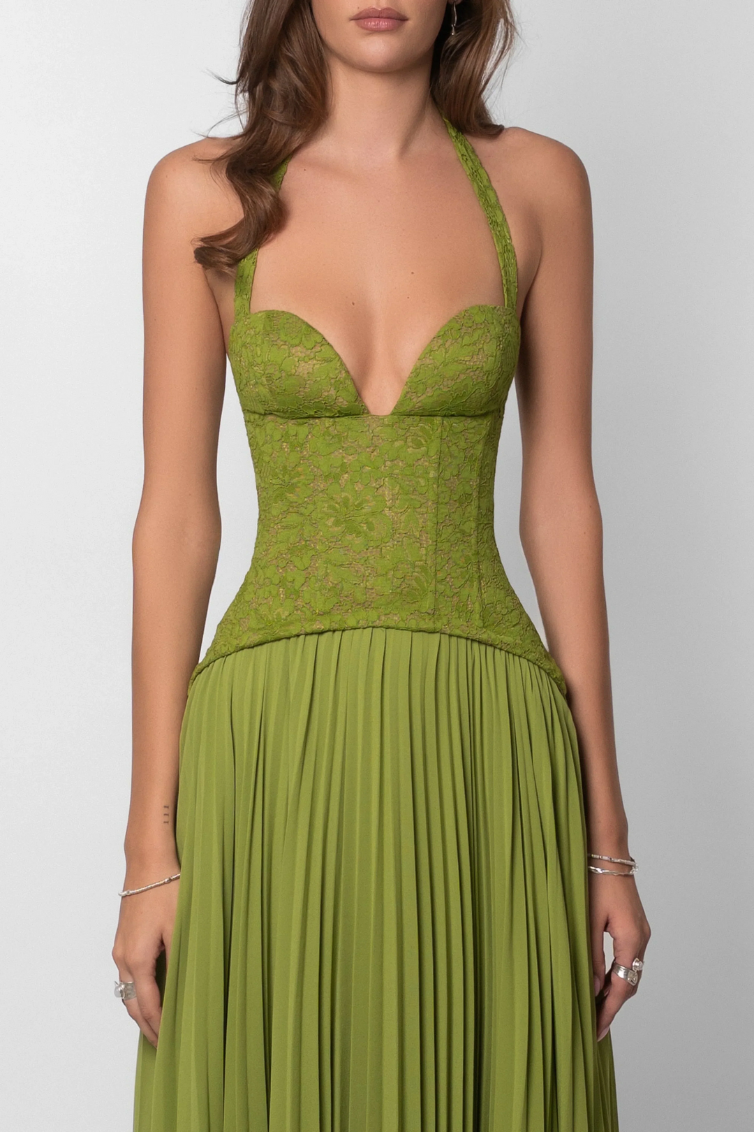 Eye-catching green pleated maxi dress with a corset top, ideal for elegant occasions & wedding guests.