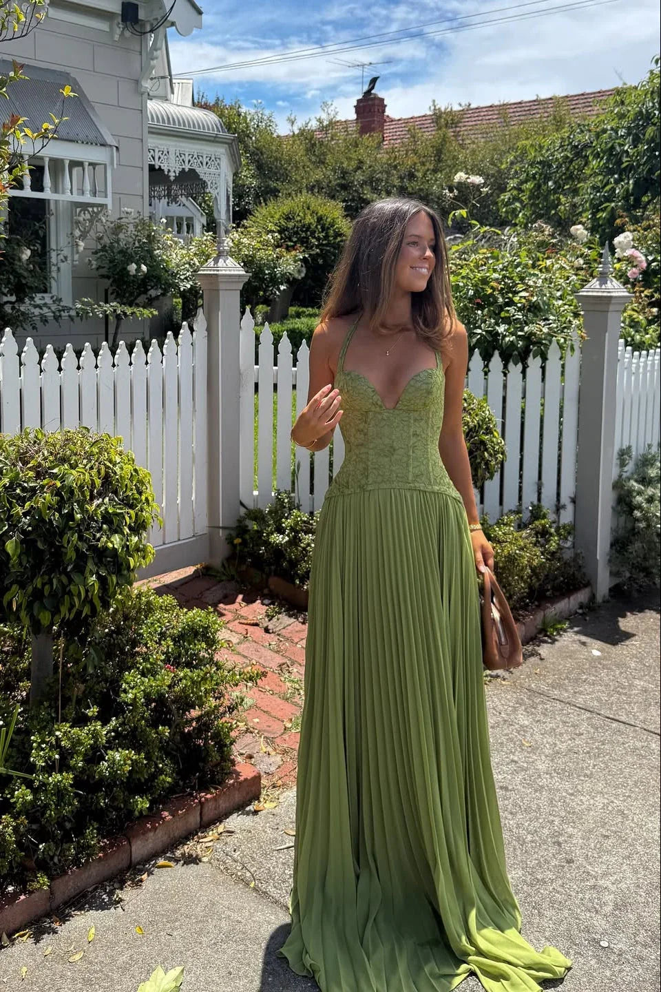 Stunning green pleated maxi dress with corset detail. Ideal for special occasions and party wear.