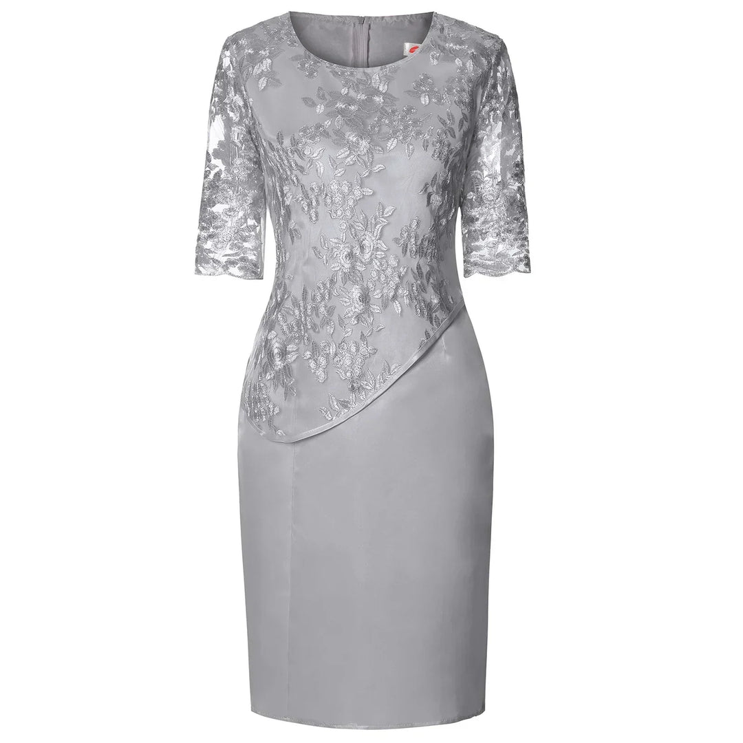 Pink plus size elegant knee-length dress featuring beautiful floral embroidery & a sheer overlay.