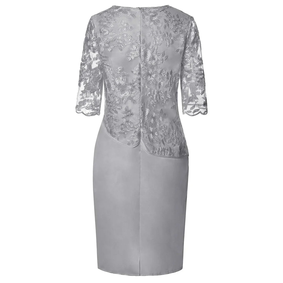Women's pink elegant embroidered overlay knee-length party dress with a round neck and short sleeves.