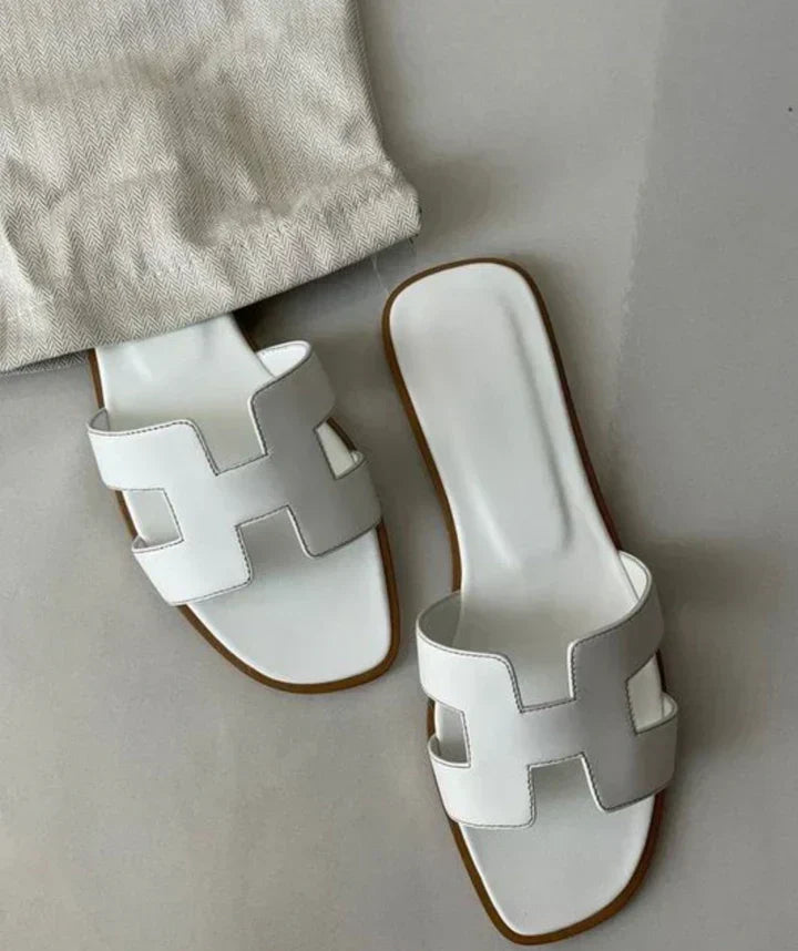 Women's elegant H-strap slip-on leather sandals with low heel for summer comfort.