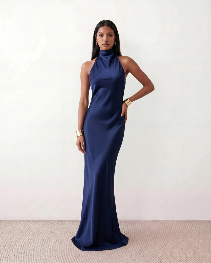 Elegant women's halter neck maxi dress, versatile for casual summer days or chic evening wear.