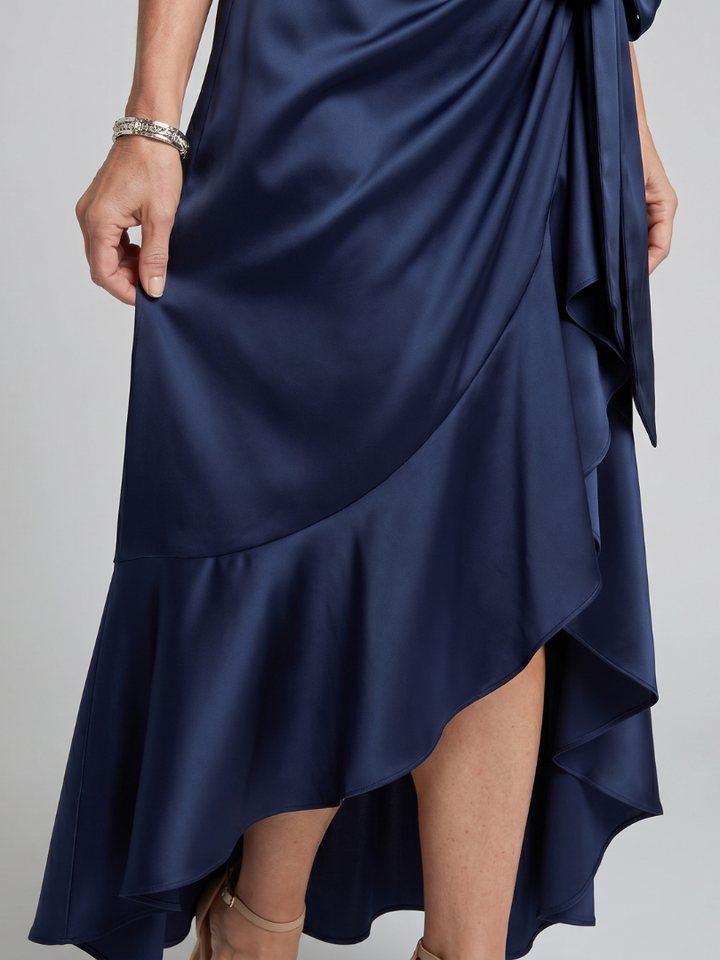 Elegant women's sleeveless party midi dress. Halter neck with chic asymmetric hem detail.