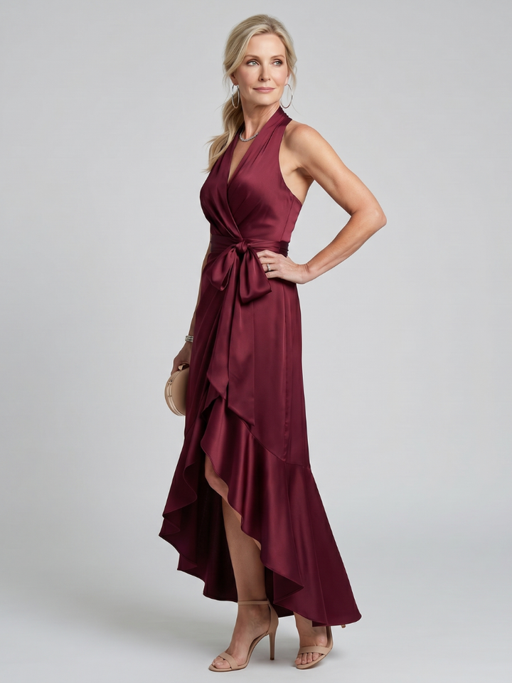 Sophisticated women's halter neck wrap midi dress. Elegant asymmetric hem for parties.
