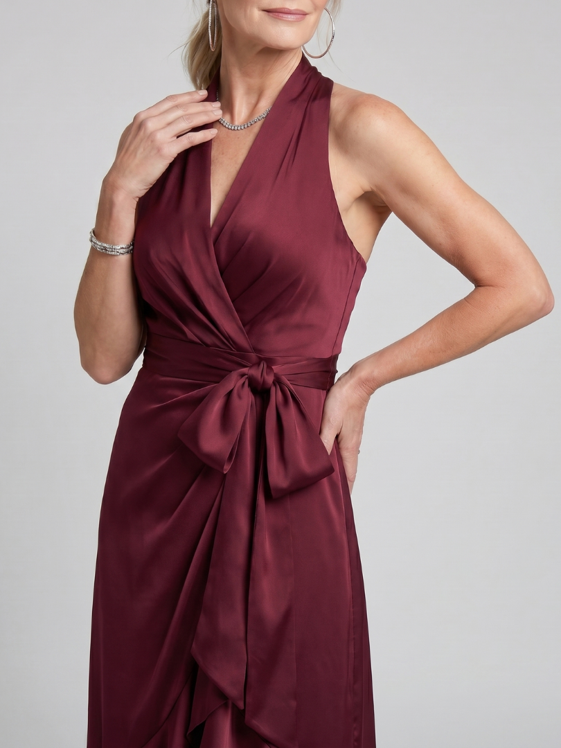 Women's sleeveless elegant midi dress. Halter neck, flattering wrap, unique asymmetric hem.