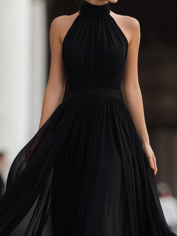 Formal women's pleated halter neck maxi dress, an elegant choice for evening wear, parties & celebrations.