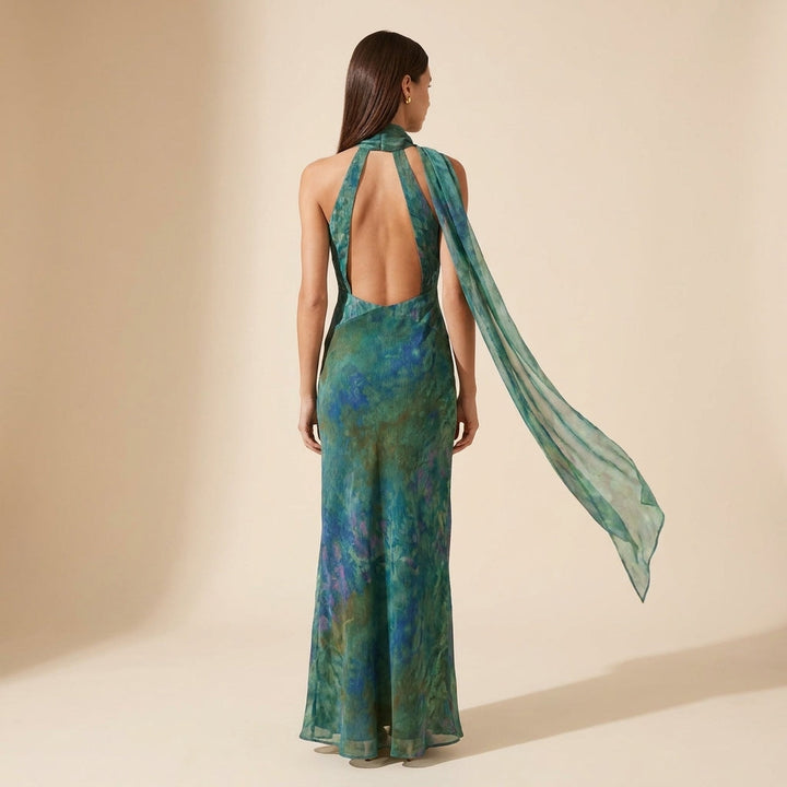 Stylish women's sleeveless maxi dress, features a vibrant print and halter neck design, ideal for summer fashion.