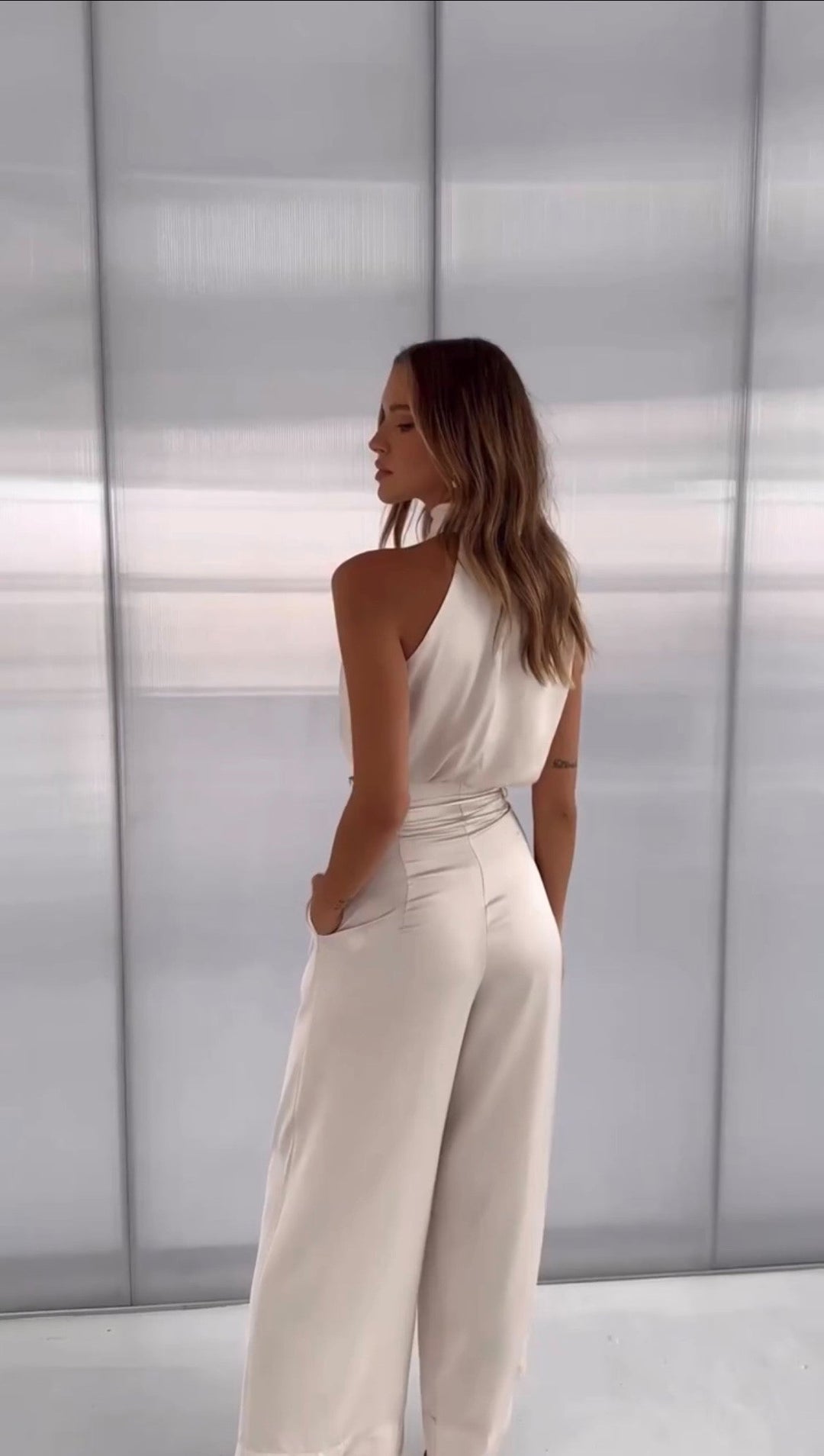 Stylish women's party outfit: elegant halter top & wide-leg pants set. Chic two-piece for evening and special events.