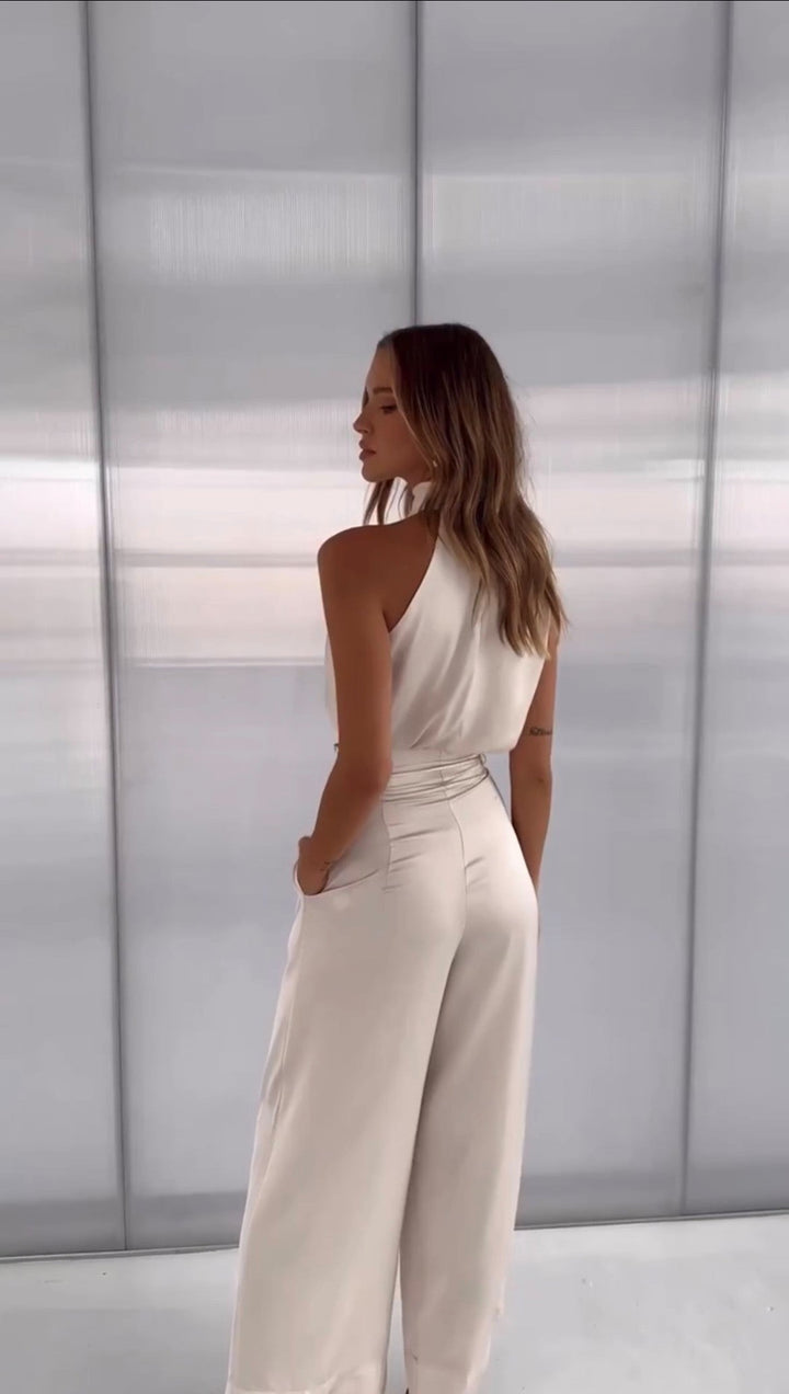 Stylish women's party outfit: elegant halter top & wide-leg pants set. Chic two-piece for evening and special events.