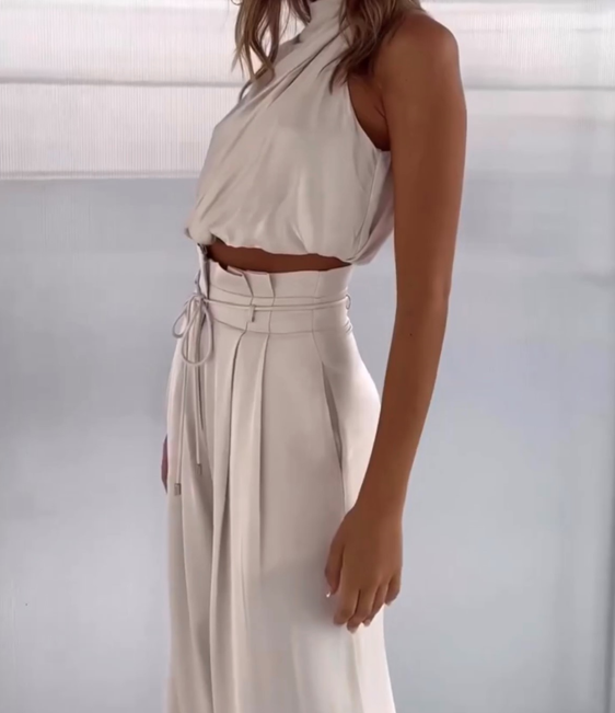 Flowy women's elegant halter top & wide-leg pants set. Stylish two-piece ensemble, perfect for summer evening wear.