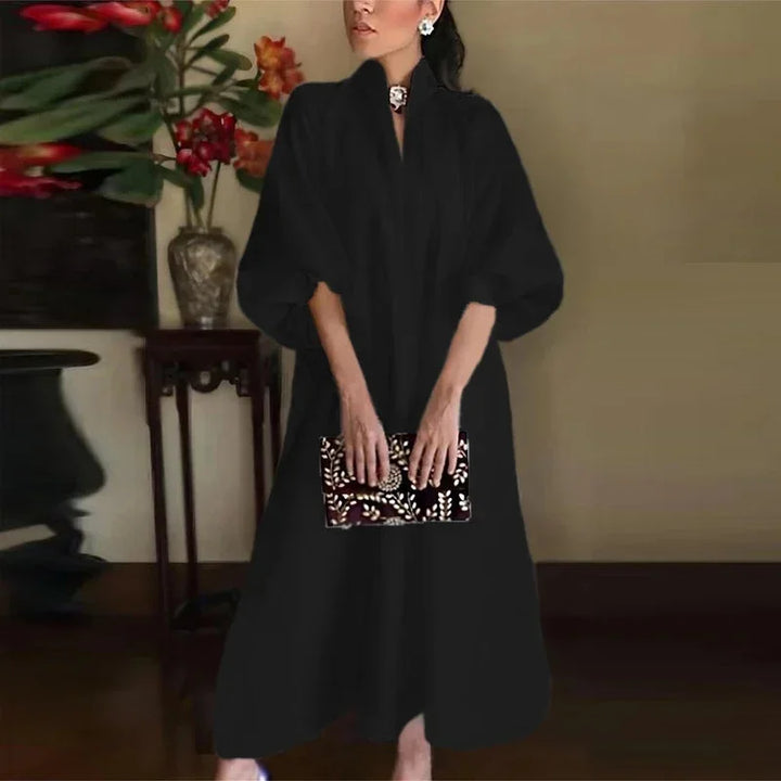 Chic full-length women's maxi dress. Features a fashionable high-neck, balloon sleeves, & comfortable loose fit.