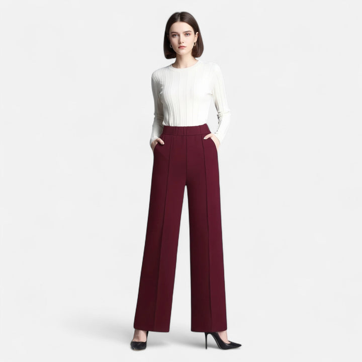 Close-up of women's black high-waist wide-leg dress pants, showcasing fabric and detail.