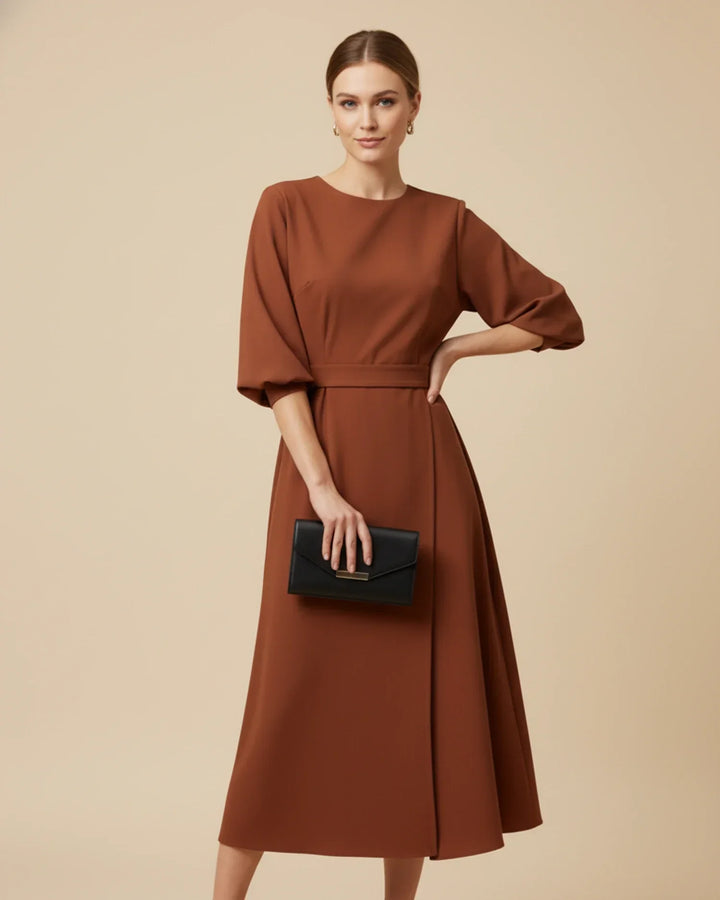 A must-have fashion midi dress with a timeless wrap design and stylish belt.