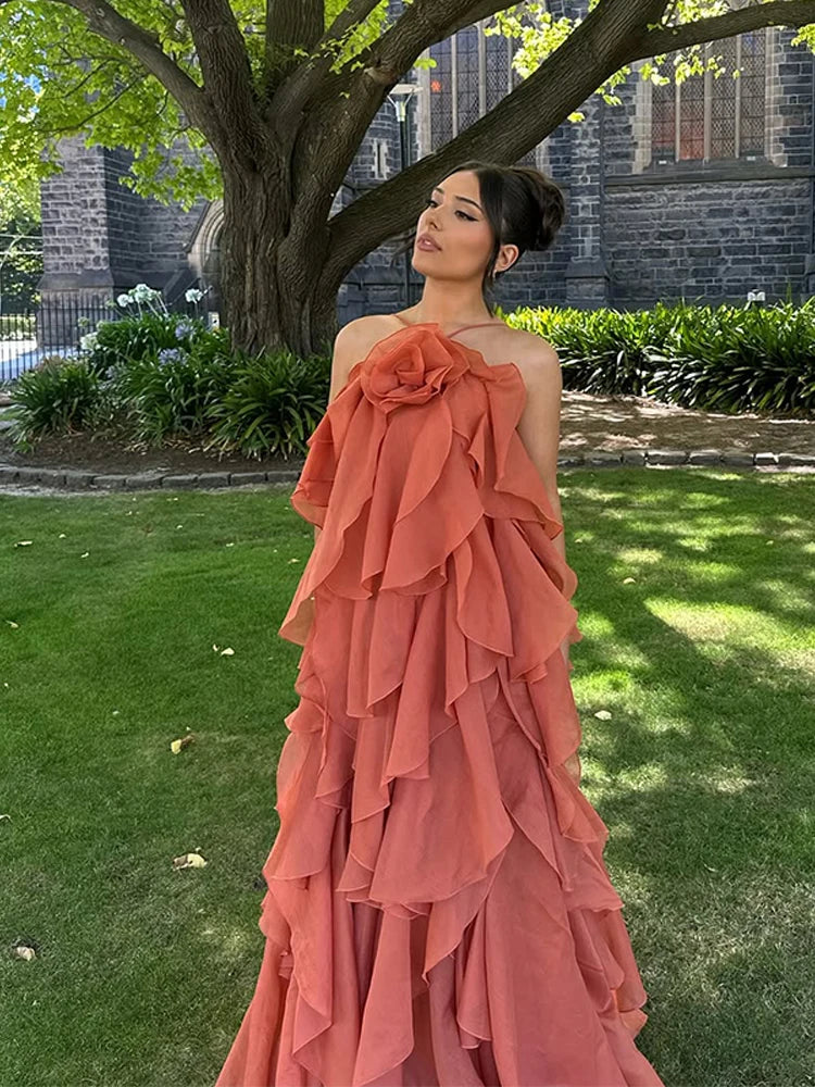 Close-up of the elegant floral neckline on a women's flowy layered ruffle maxi dress. Perfect for resort wear.