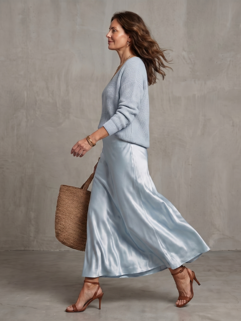 Women's long-sleeve layered top and elegant midi skirt ensemble. Versatile chic wear.
