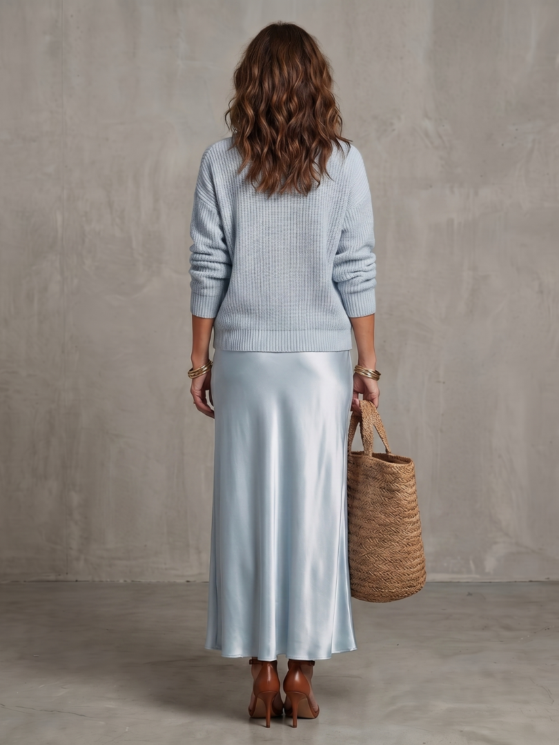 Women's two-piece elegant layered sweater and flowing midi skirt for sophisticated style.