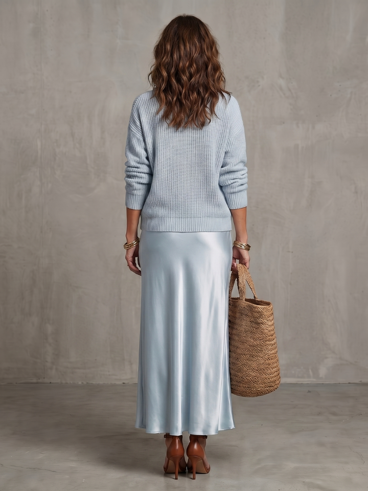 Women's two-piece elegant layered sweater and flowing midi skirt for sophisticated style.