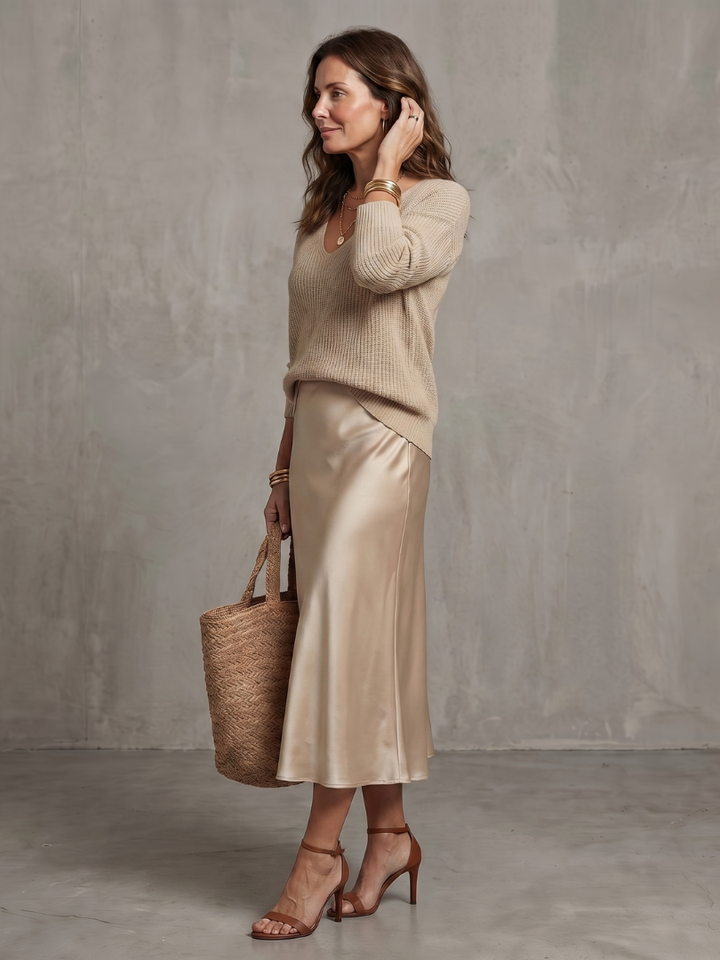 Elegant women's layered sweater and flowing midi skirt set. Chic and perfect for various occasions.