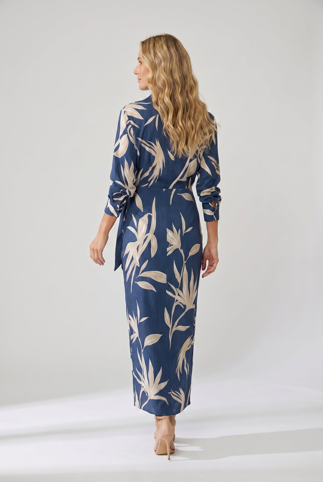 Front view of a women's leaf print maxi wrap dress, elegant V-neck and long sleeves.