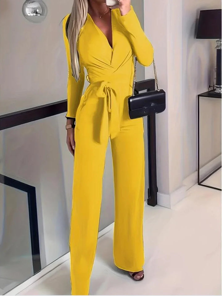 Stylish women's wide-leg V-neck jumpsuit with long sleeves and tie waist, suitable for elegant and casual occasions.