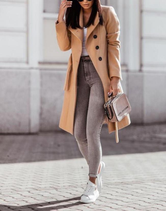 Elegant women's long double-breasted winter coat with a tie waist, ideal for classic cold weather fashion.