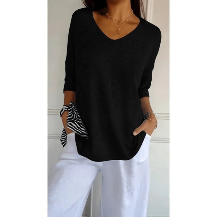 Textured knit women's top, featuring a flattering V-neck, half sleeves, and a comfortable loose fit.