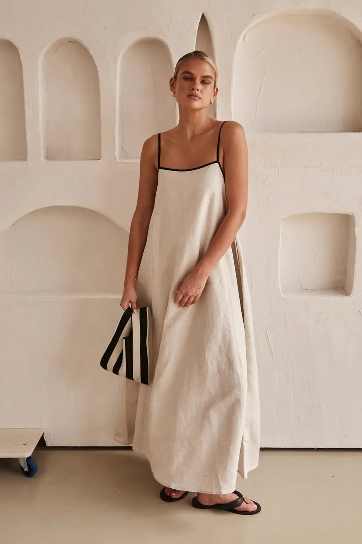 Women's elegant maxi summer dress with contrast trim, adjustable straps, and side pockets. Perfect for vacation.