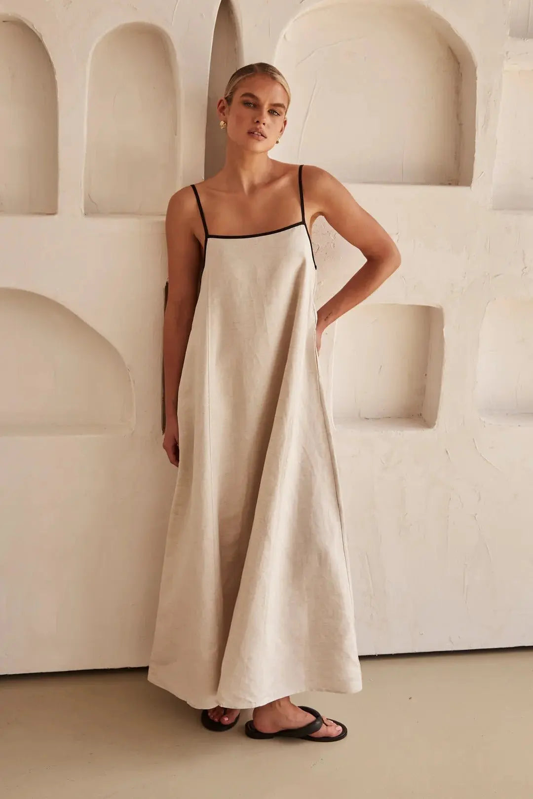 Flowy trapeze maxi beach dress for women, featuring chic contrast trim and comfy adjustable straps. Resortwear essential.