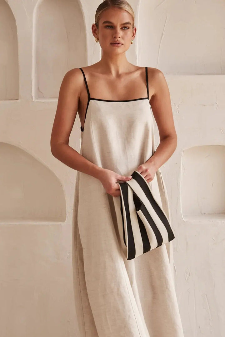 Casual women's maxi dress with adjustable straps and stylish contrast trim. Ideal for summer and comfortable all-day wear.