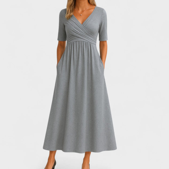 Women's elegant midi dress with flattering V-neck, elbow sleeves, flared skirt, and practical side pockets.