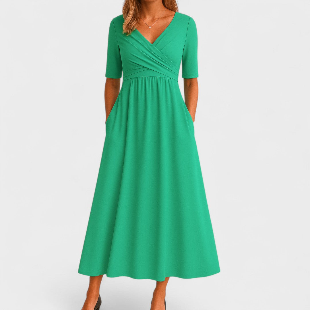 Model wearing a flattering V-neck midi dress with elbow sleeves, flared skirt, and convenient pockets.