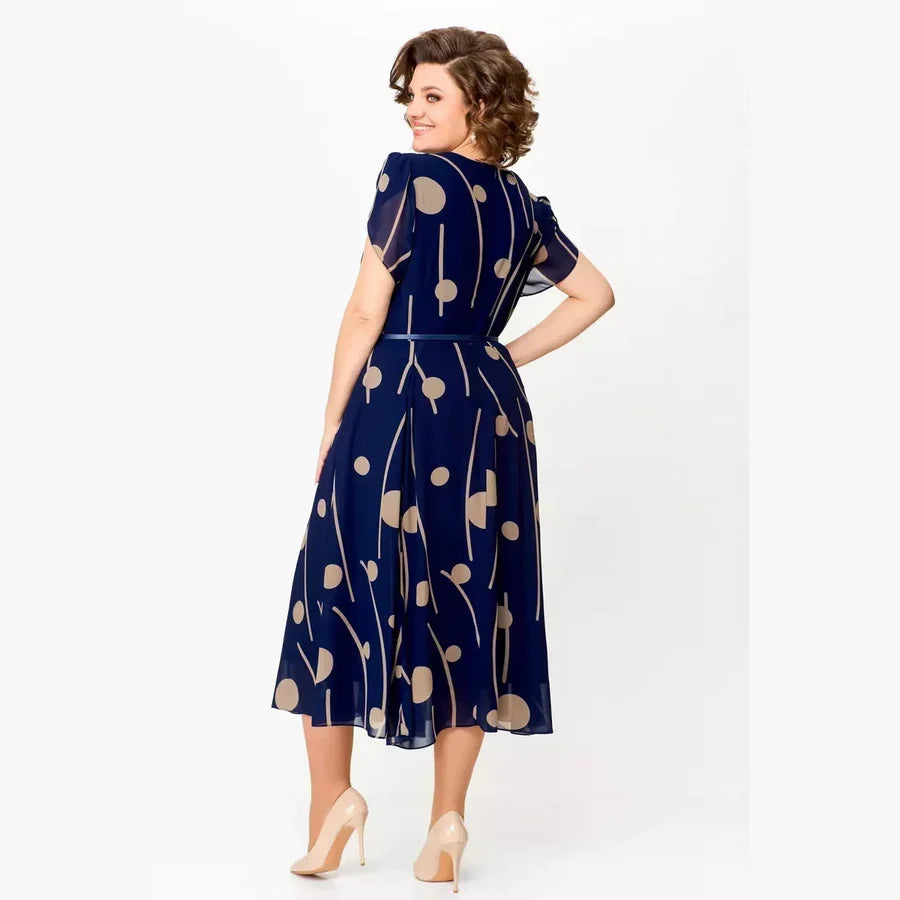 Flowy navy polka dot midi dress for women, flattering and comfortable with a vintage-inspired style.