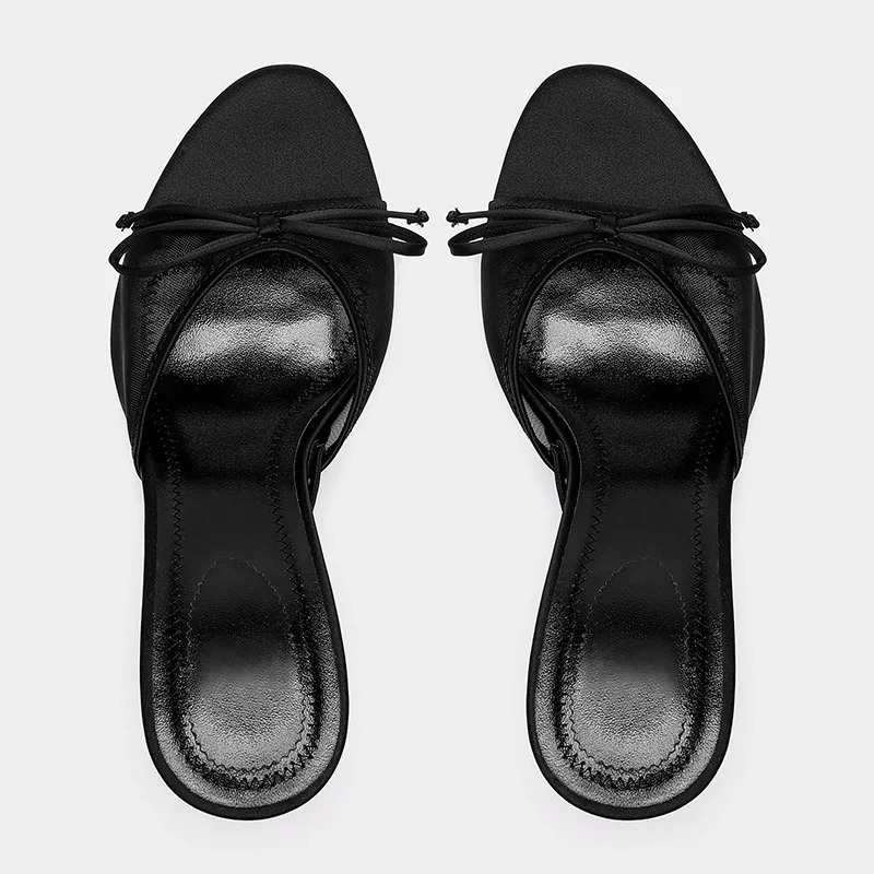 Close-up of the comfortable kitten heel on women's elegant open toe mule sandals. Slip-on fashion shoes.