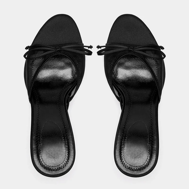 Close-up of the comfortable kitten heel on women's elegant open toe mule sandals. Slip-on fashion shoes.