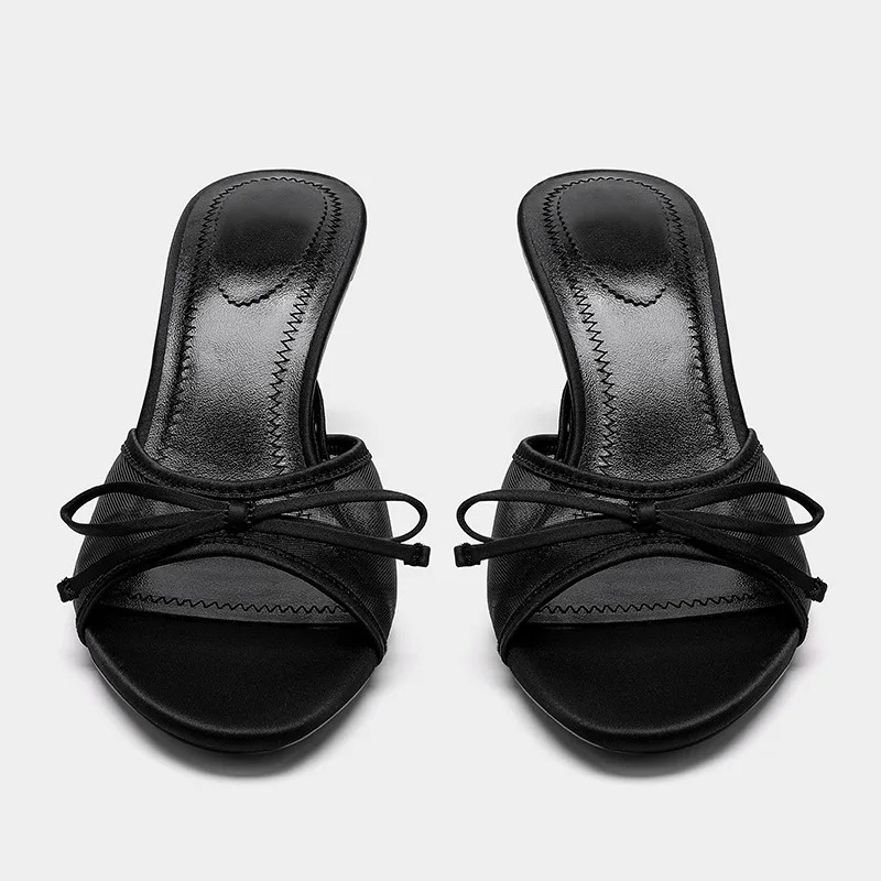 Chic side profile of women's open toe kitten heel mule sandals. Stylish animal print, comfortable slip-ons.