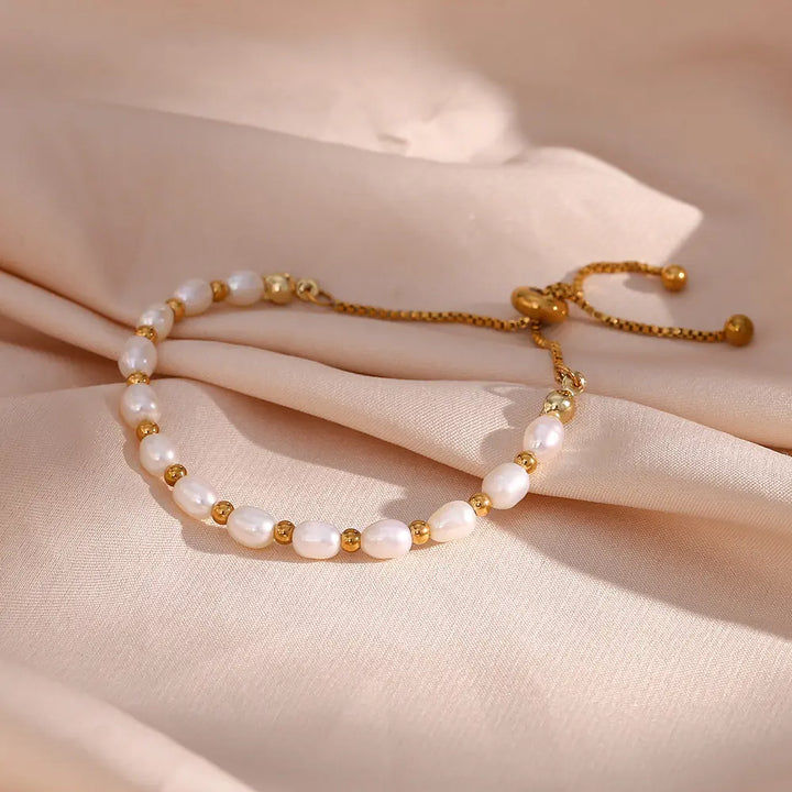 Women's elegant pearl & gold chain bracelet, a delicate fashion accessory for any outfit.