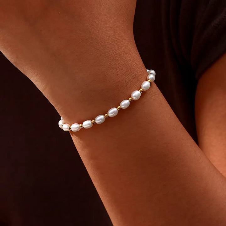 Classic women's gold bracelet with lustrous pearls, ideal elegant wrist jewelry for special occasions.