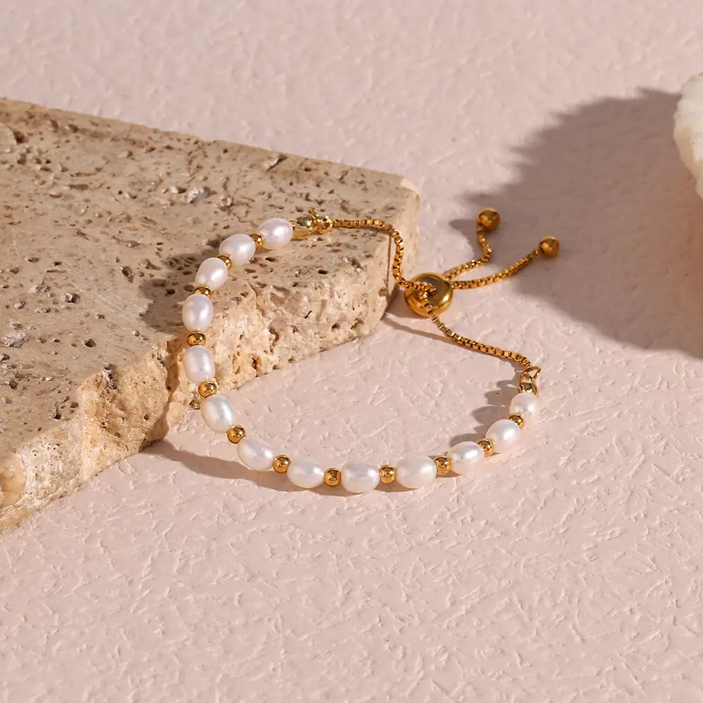 Handcrafted women's gold bracelet featuring shimmering freshwater pearls, timeless elegant jewelry.