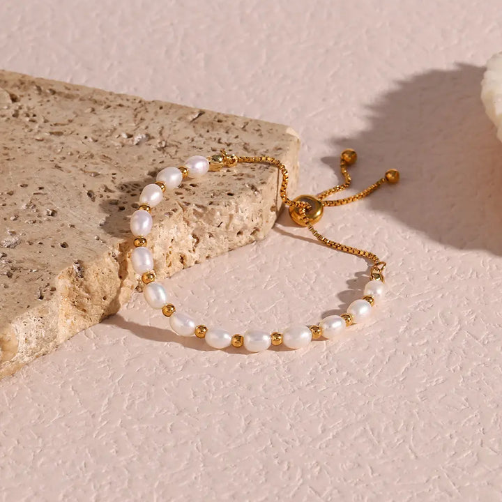 Handcrafted women's gold bracelet featuring shimmering freshwater pearls, timeless elegant jewelry.