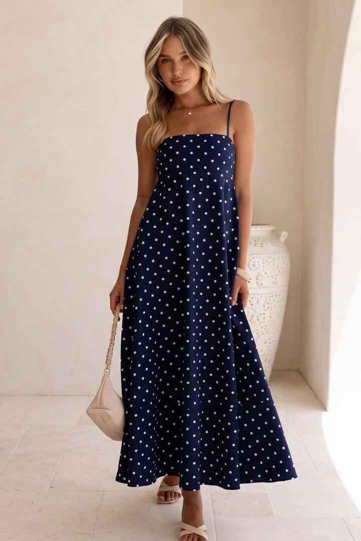Trendy women's polka dot maxi dress with sleeveless cut, perfect as a casual summer dress or evening gown.