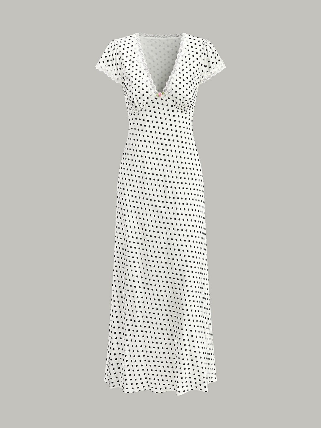 Model wearing an elegant A-line polka dot maxi dress with V-neck.