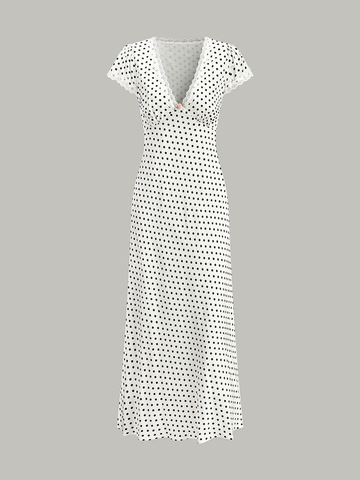 Model wearing an elegant A-line polka dot maxi dress with V-neck.