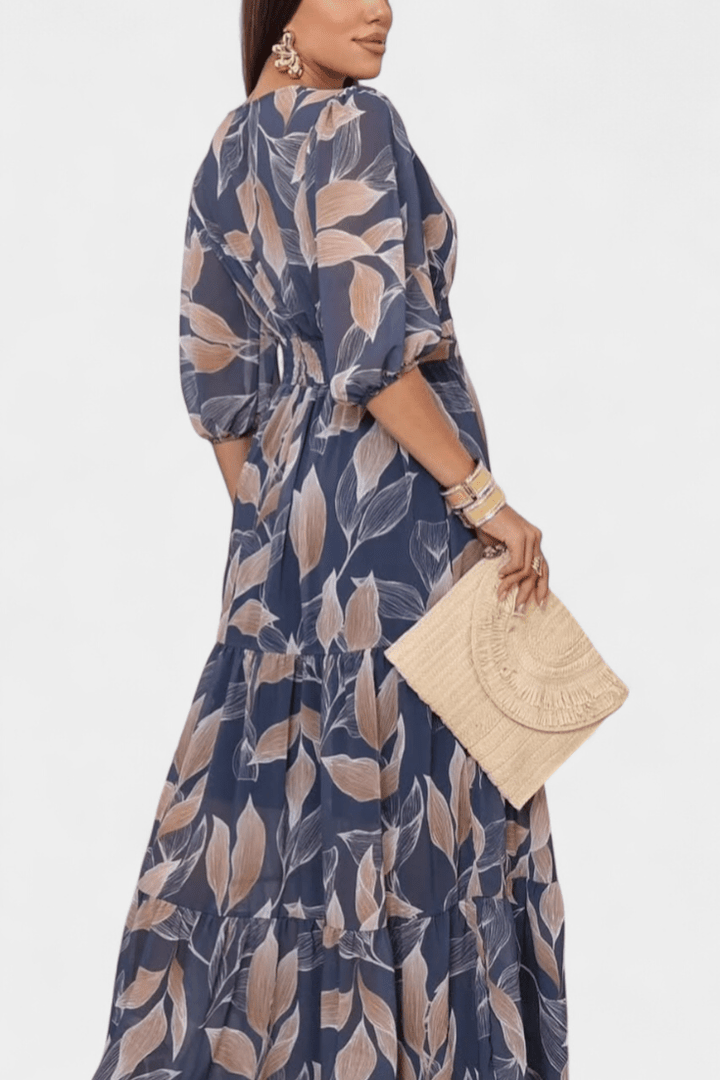 Vibrant printed maxi dress for women. Elegant V-neck, flowing long sleeve silhouette, perfect for spring.