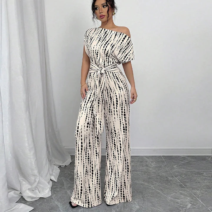 Women's elegant printed one-shoulder wide-leg jumpsuit with a stylish belt, perfect for evening wear or parties.