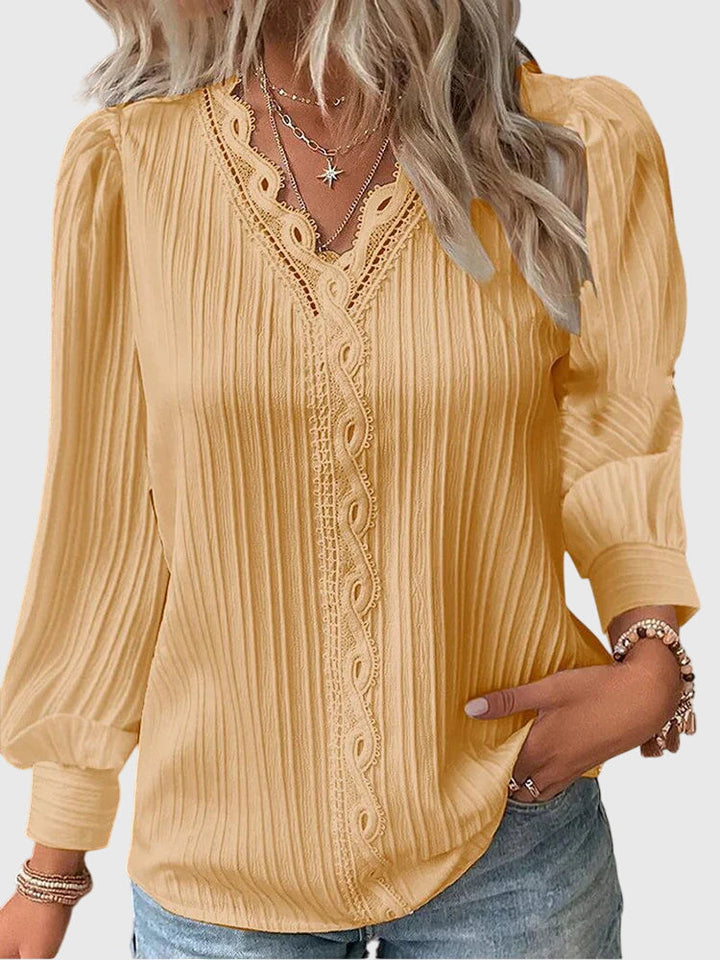 Women's elegant pullover blouse, perfect for chic style. Versatile long sleeve top for any occasion.
