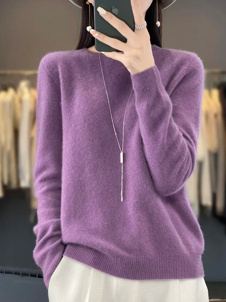 Detail of fine knit on a women's round neck sweater, enhancing its elegant and casual appeal.