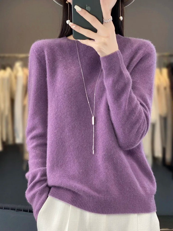 Detail of fine knit on a women's round neck sweater, enhancing its elegant and casual appeal.