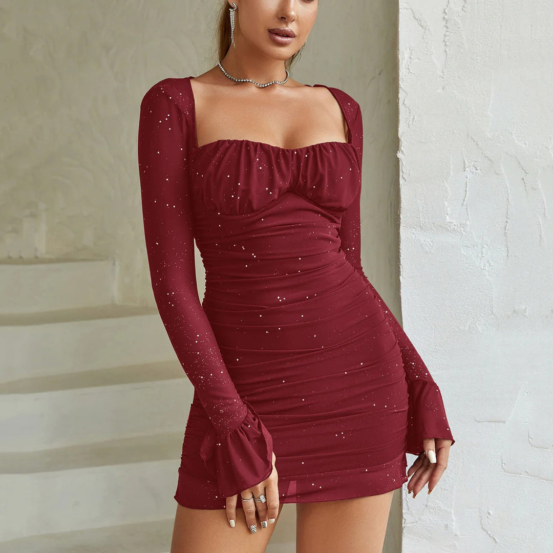 Glittering women's fitted ruched mini dress with long sleeves & flared cuffs. A flattering choice for evening parties.