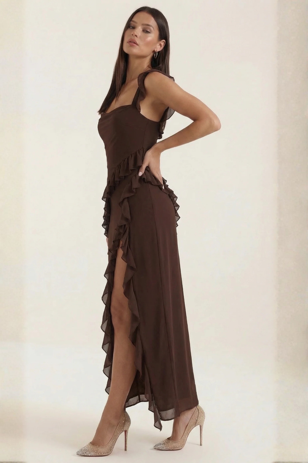 Modern sleeveless special occasion dress for women, with elegant ruffle detail and a side slit.