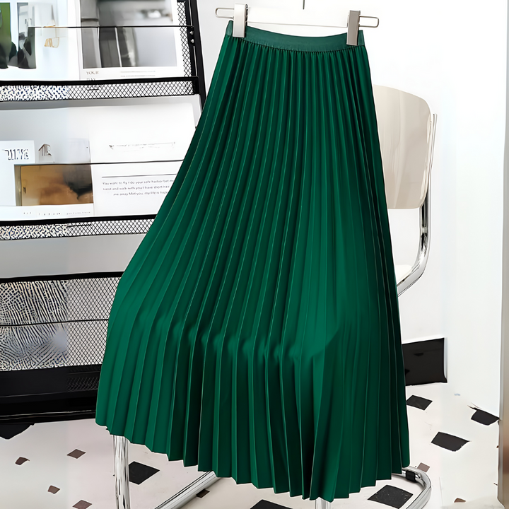 Close-up of the luxurious texture of a women's satin pleated midi skirt.